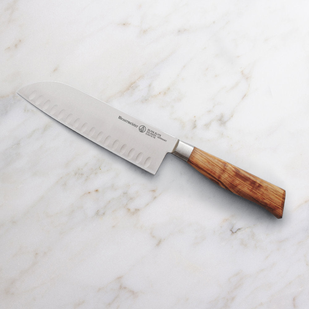 Messermeister Oliva Elite 7-inch Kullens Santoku Knife on Marble Counter