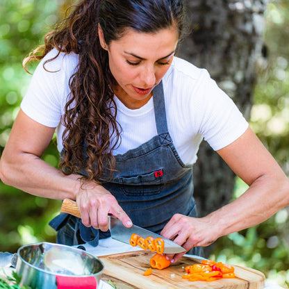 Messermeister Oliva Elite 8-inch Chef's Knife in Use Outside Slicing Peppers