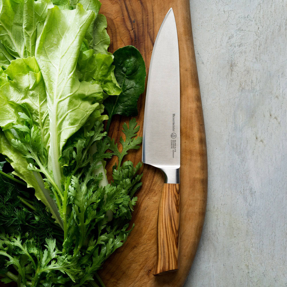 Messermeister Oliva Elite 8-inch Chef's Knife on Board with Greens