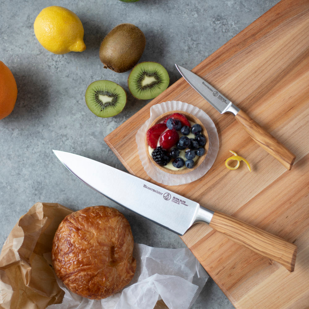Messermeister Oliva Elite 3.5-inch Paring Knife on Board with Chef's Knife and Fruit