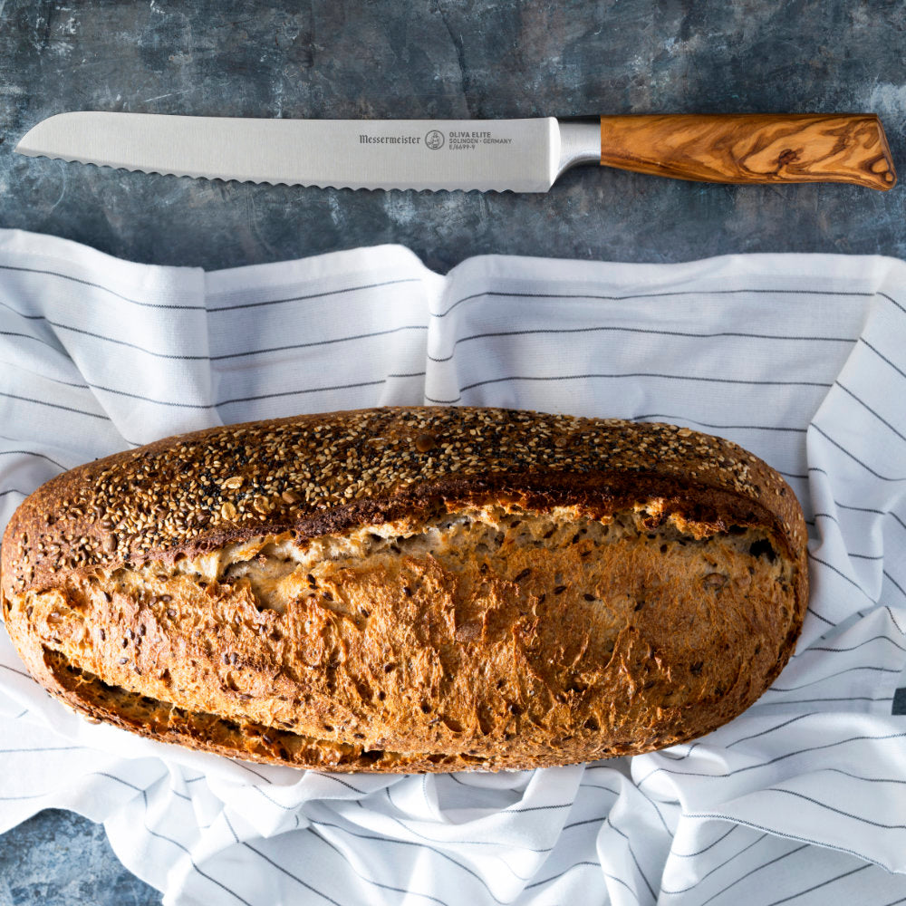 Messermeister Oliva Elite 9-inch Scalloped Bread Knife with Crusty Artisanal Loaf