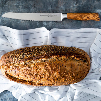 Messermeister Oliva Elite 9-inch Scalloped Bread Knife with Crusty Artisanal Loaf