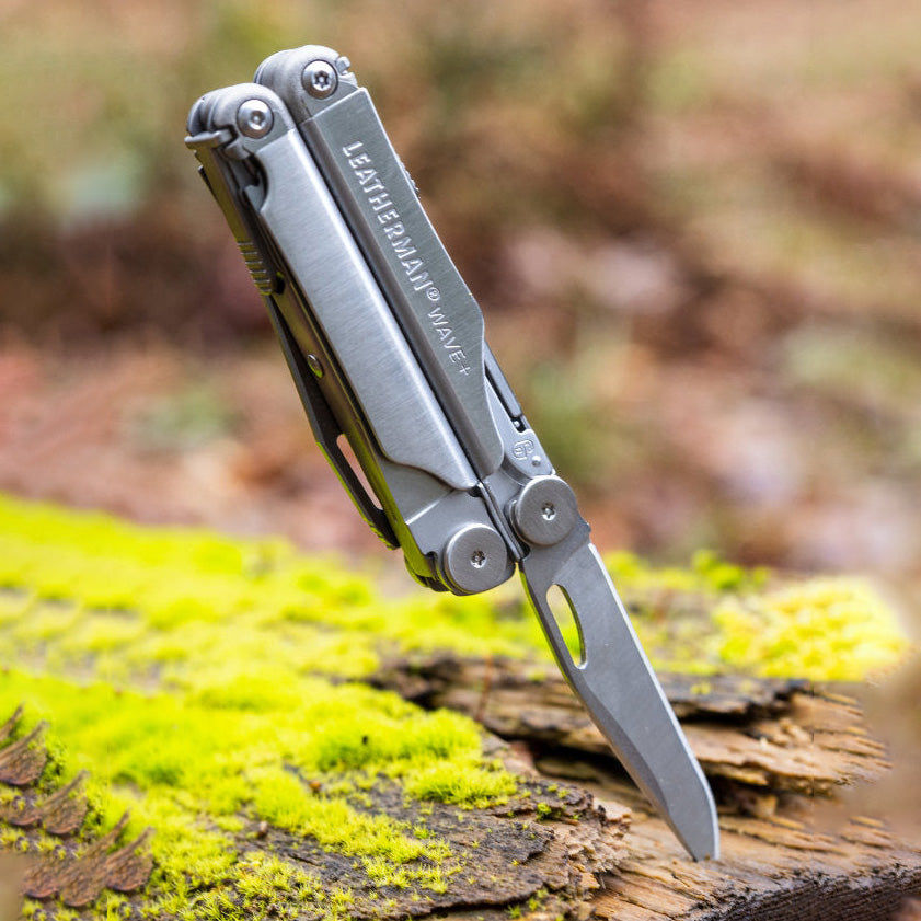 Multi-tool knife with 'Leatherman' branding on a natural background