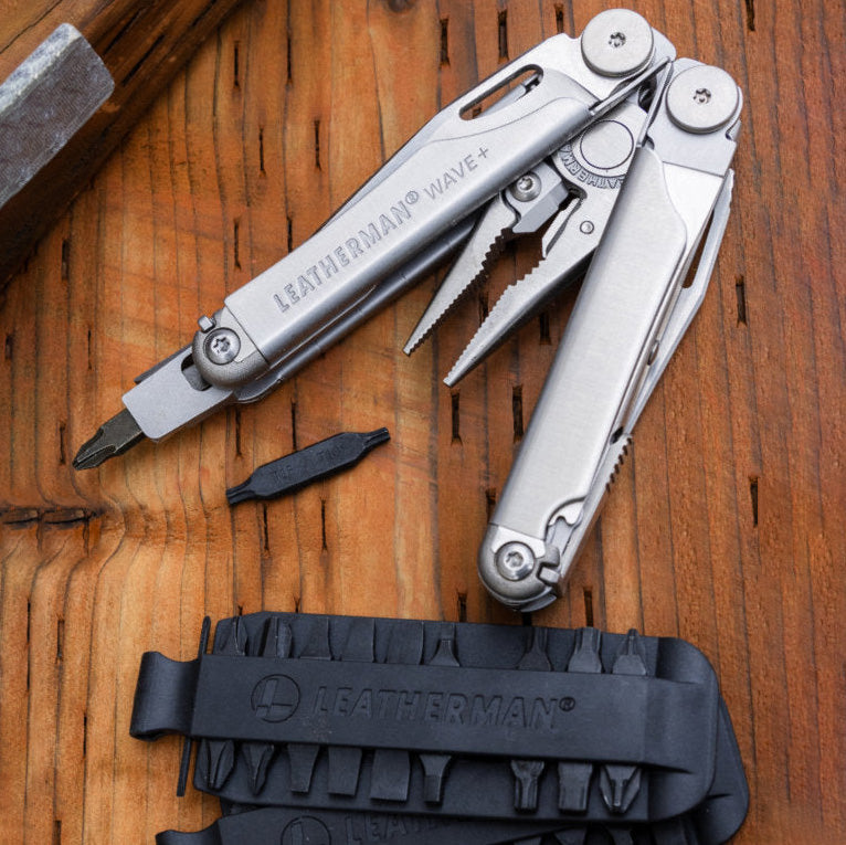Leatherman multitool with sheath on a wooden surface