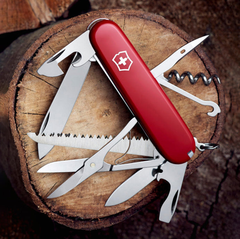 Multitool knife with various tools on a wooden surface