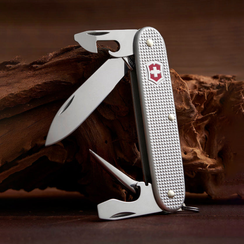 Multitool knife with a brand logo on a wooden background
